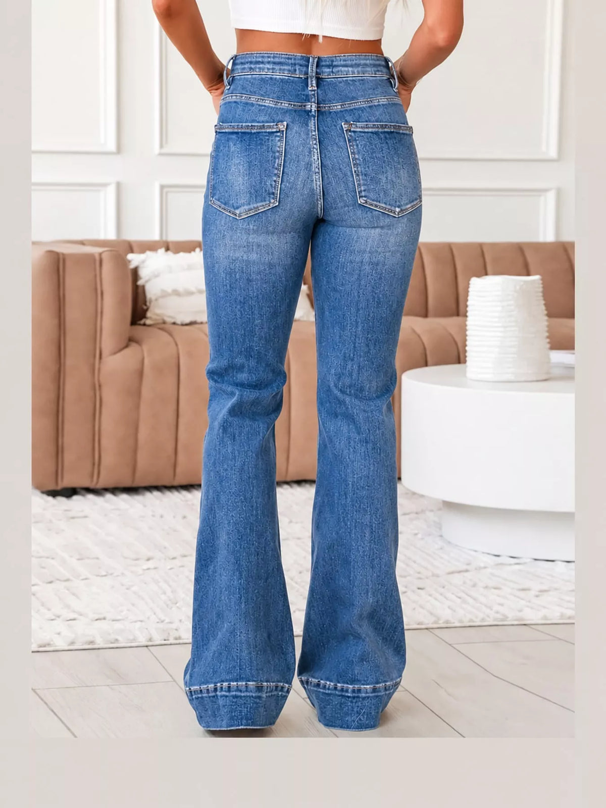 Blue high-rise flare leg jeans, back view