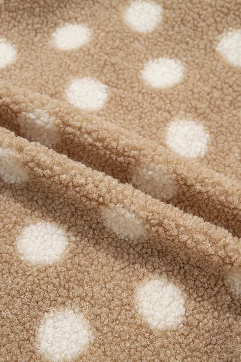 Tan and white polka dot faux fur button-front jacket with zip pockets, fabric texture detail