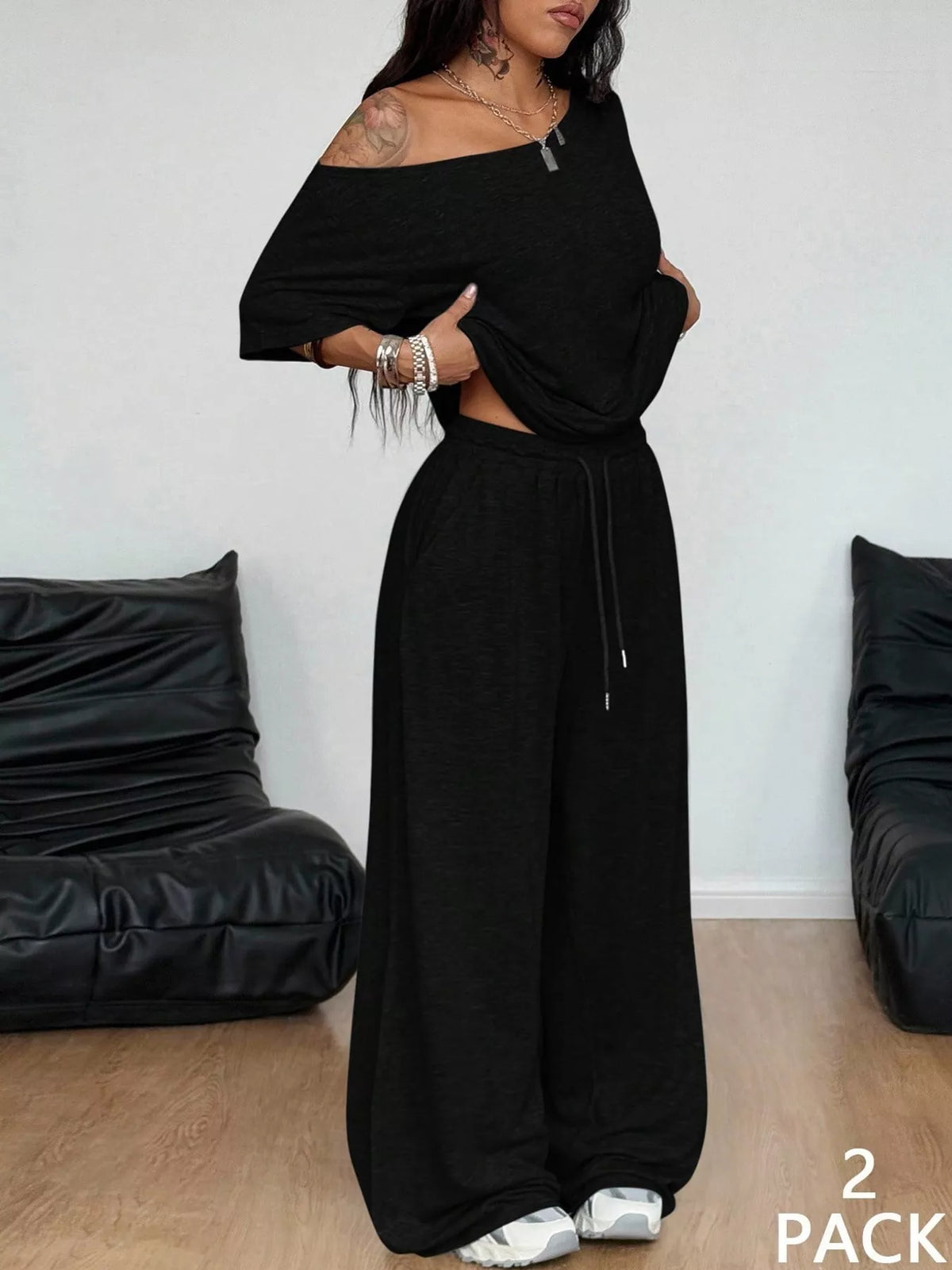 Black boat neck top and wide-leg pants set — front view