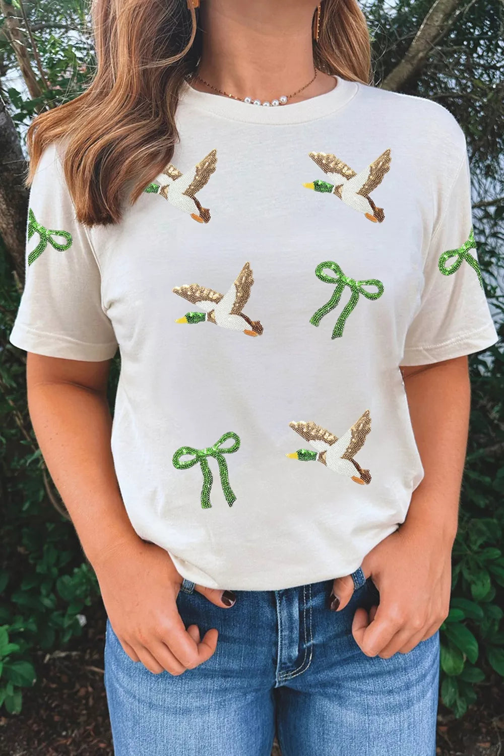 White sequin mallard and bow graphic t-shirt, front view showing short sleeves.