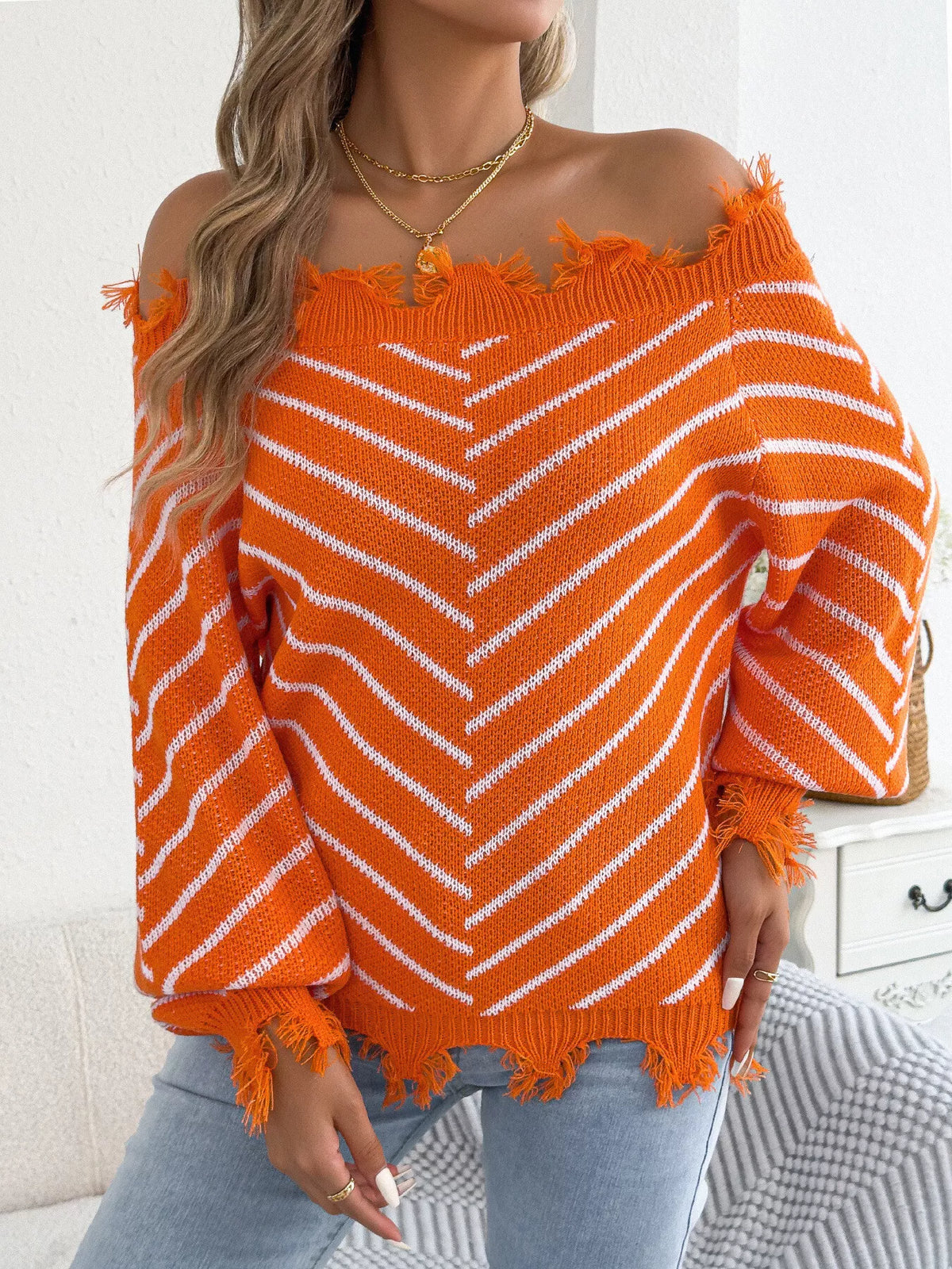 Orange off-shoulder distressed striped sweater