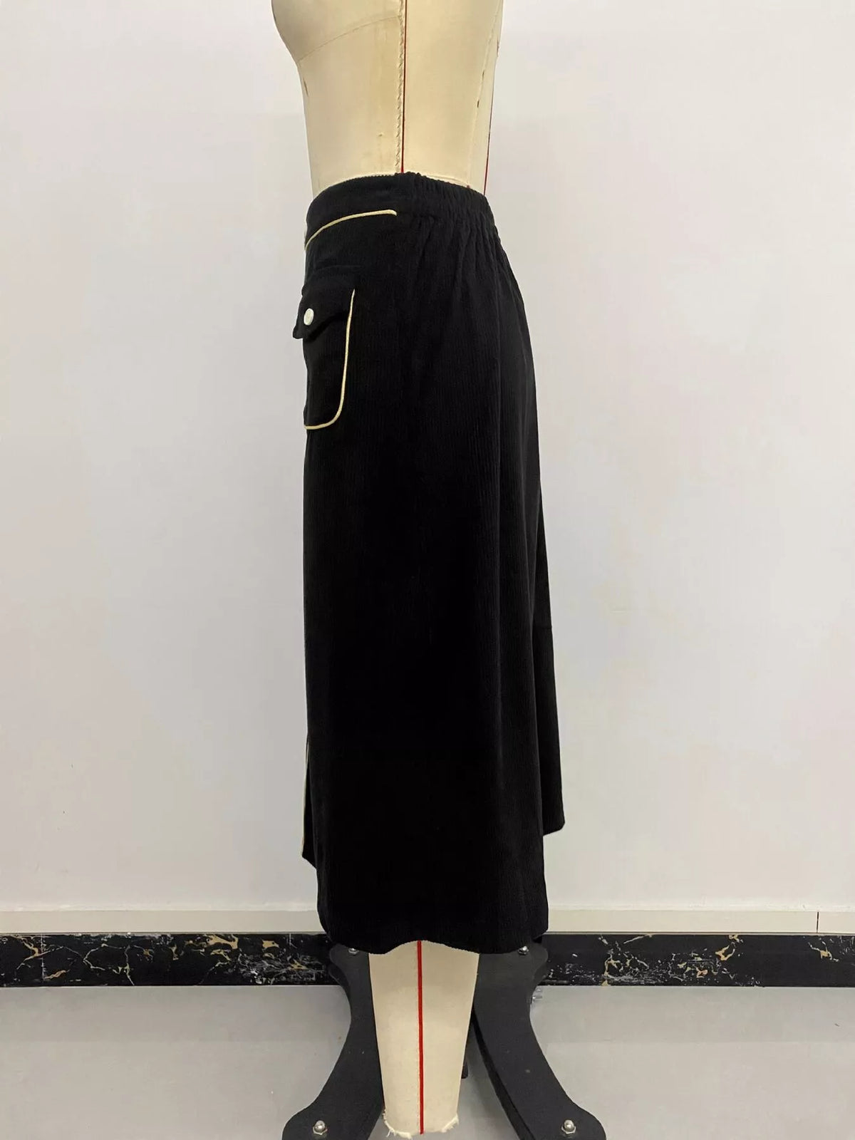 Black corduroy button-front midi skirt, side on mannequin