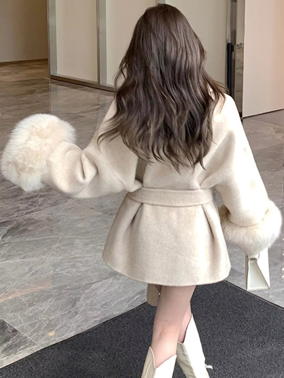 Cream tie-waist coat with faux fur cuffs — back view