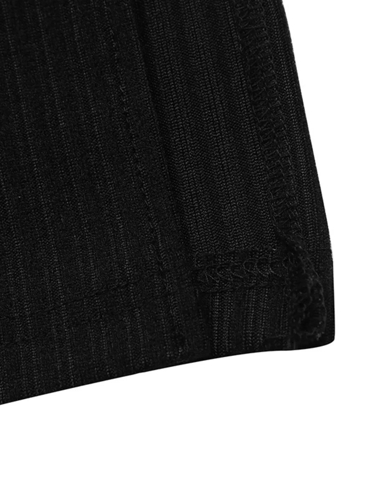 Black ribbed knit dress with white contrast trim, hem detail