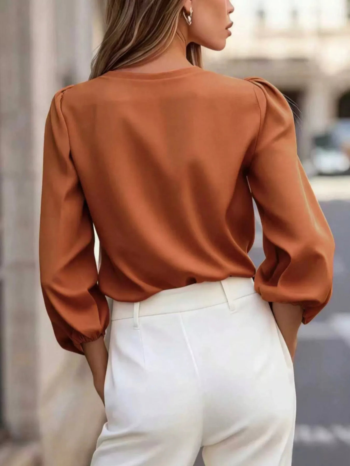 V-neck puff-sleeve button-down shirt in orange, back view