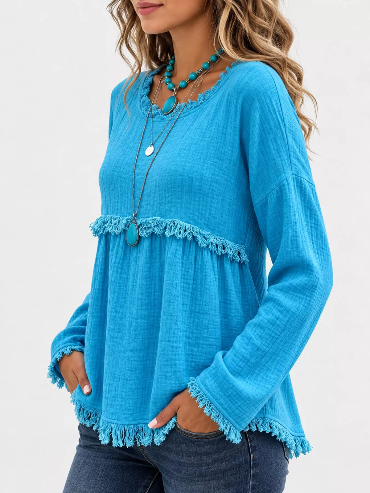 Turquoise frayed hem textured blouse, side view