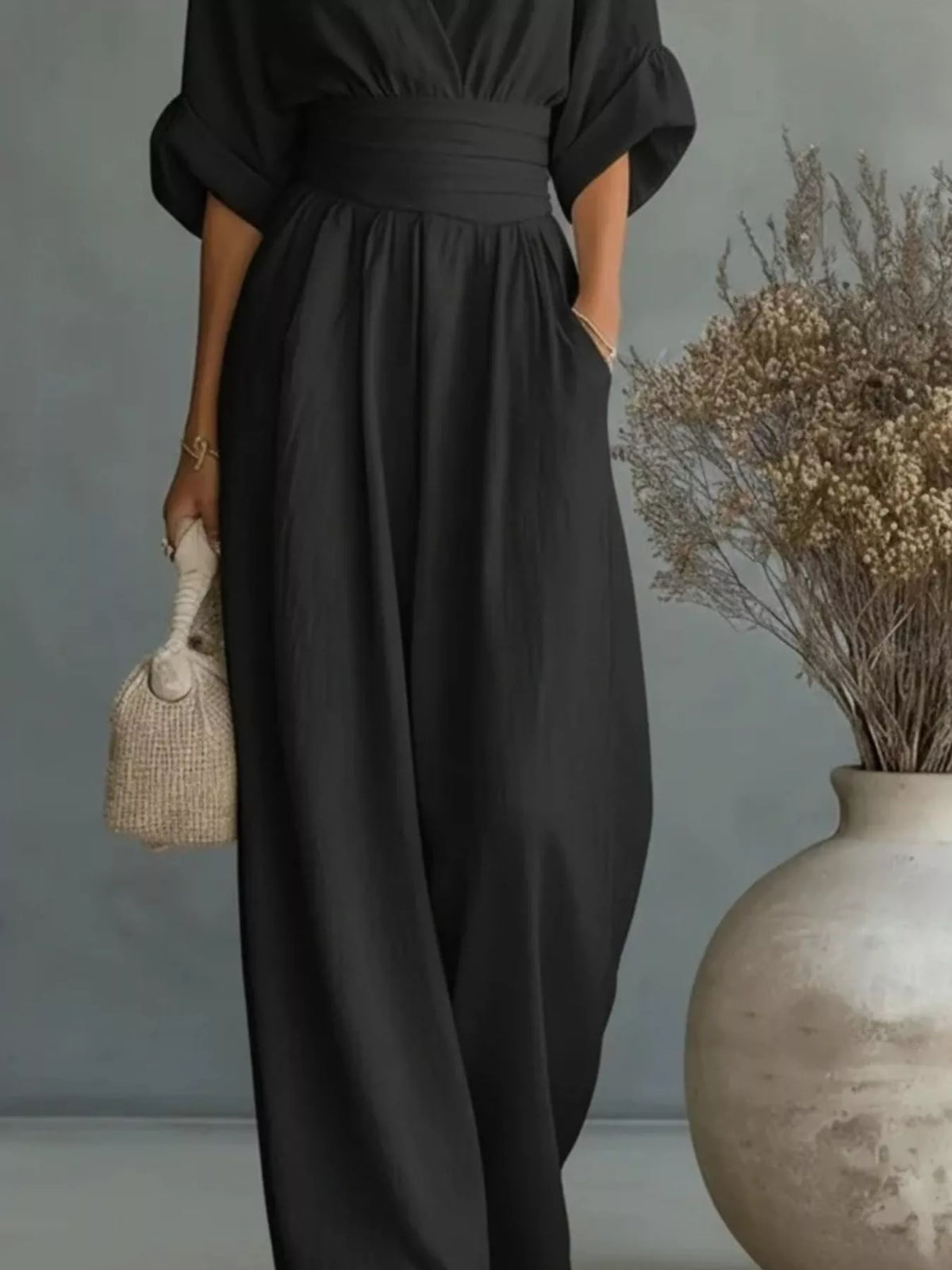 Black V-neck wide-leg jumpsuit, waist and leg detail