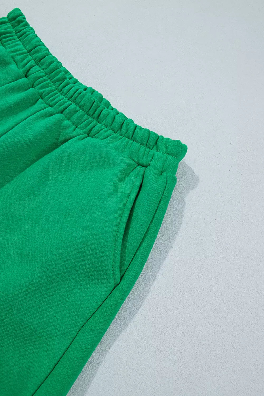 Green sweatshirt and shorts set with polka-dot trim, shorts side seam detail