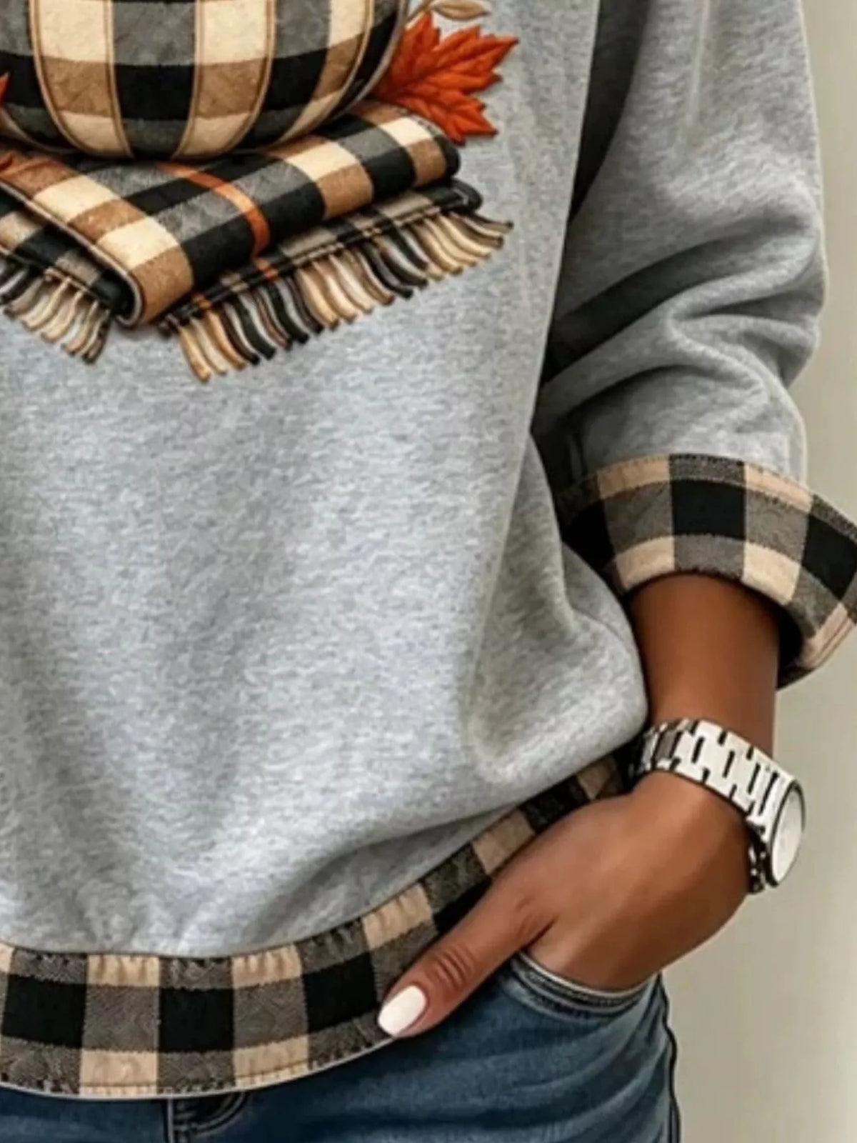 Gray pumpkin-patchwork sweatshirt, graphic and hem detail