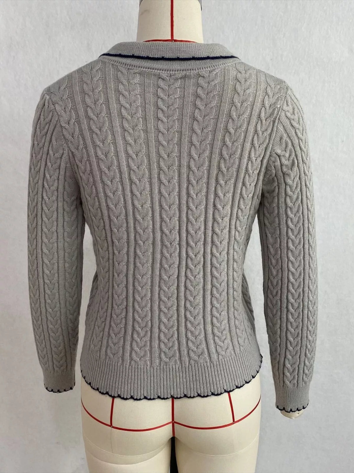Gray cable-knit polo-collar cardigan, back on dress form.