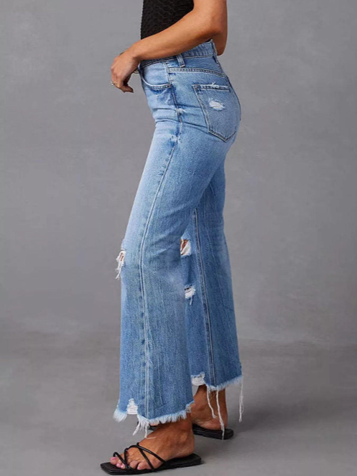 Blue distressed flare jeans — side view