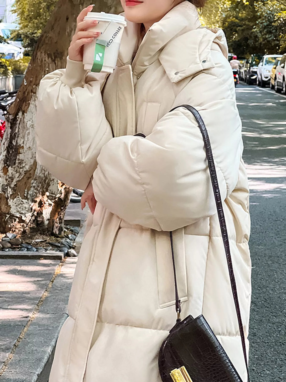 Longline puffer coat, cream angled front