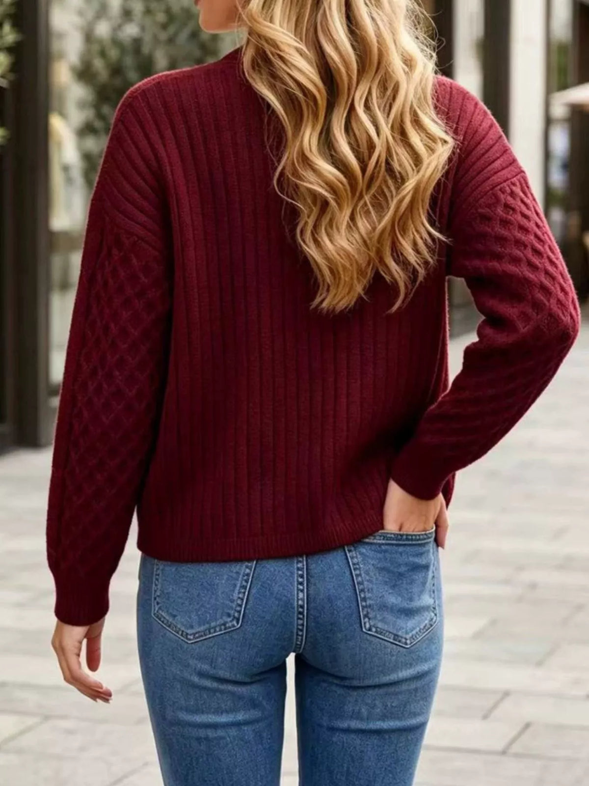 Burgundy cable-knit v-neck button-front cardigan, back view.