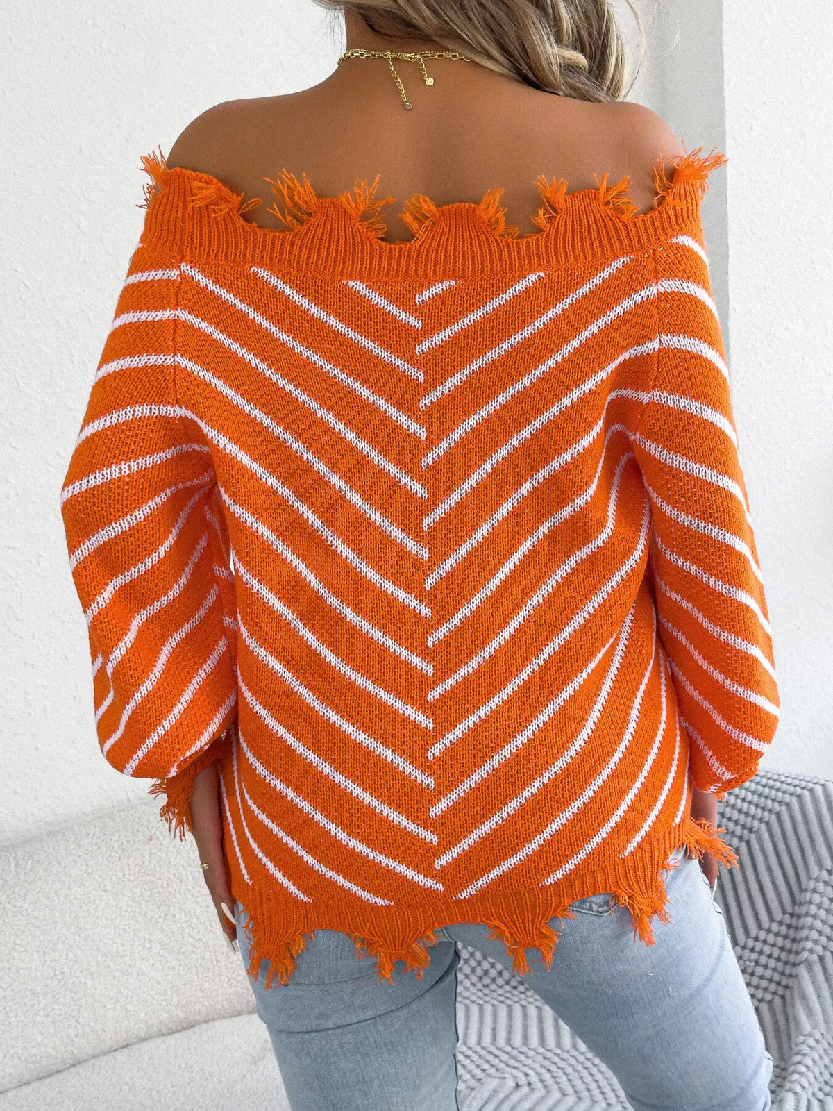 Off-shoulder distressed striped sweater, back view