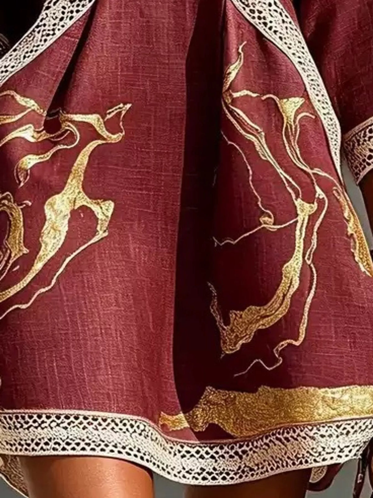 Burgundy notched 3/4 sleeve mini dress, close-up of the print and hem