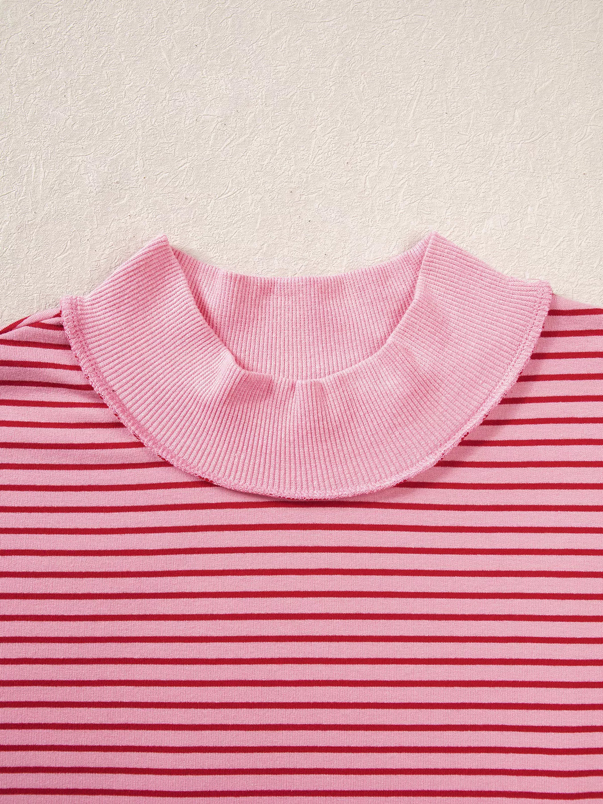 Mock neckline on pink and red striped striped color-block mock neck sweatshirt