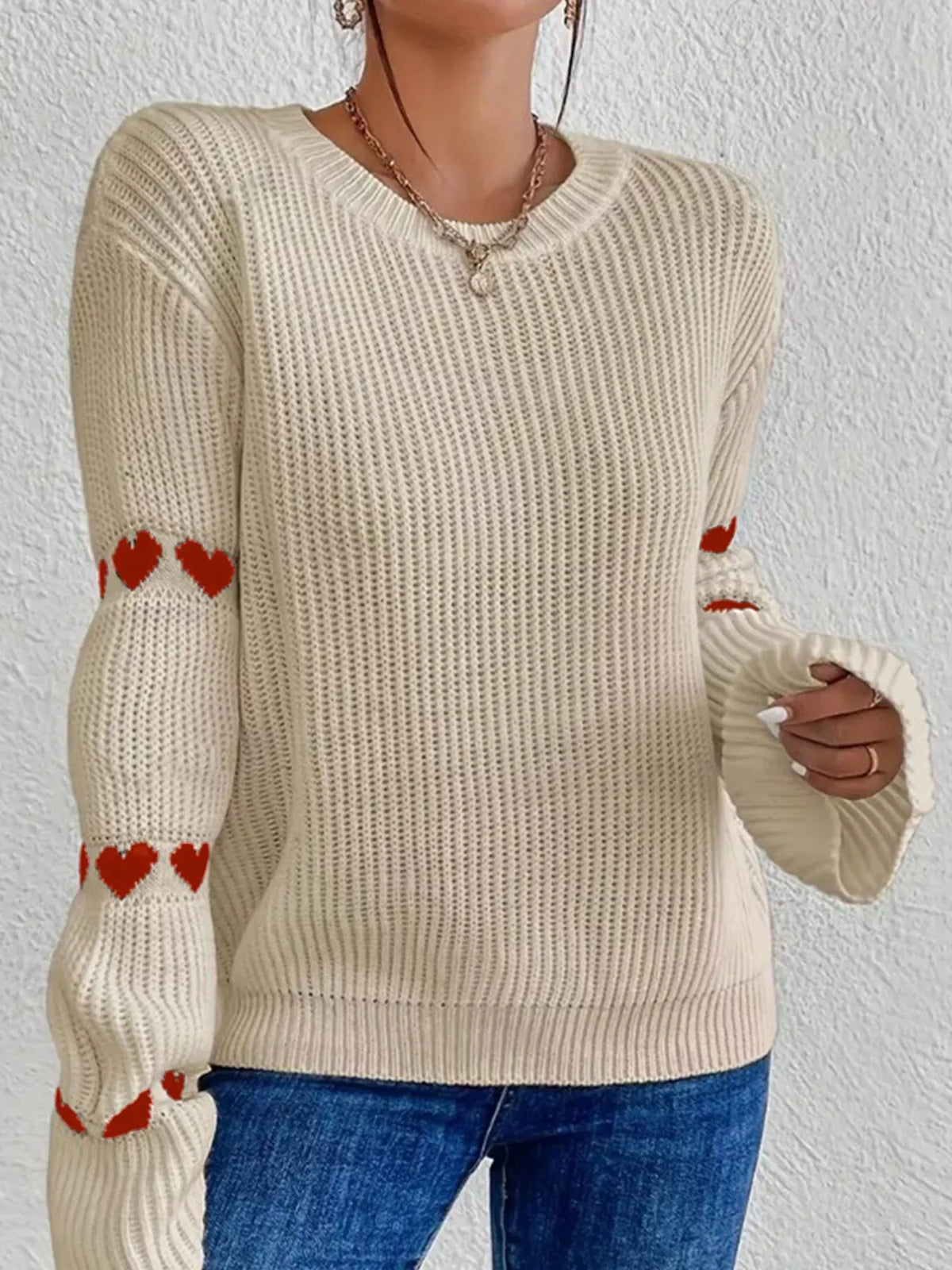 Beige and red heart-sleeve dropped-shoulder sweater, front view.