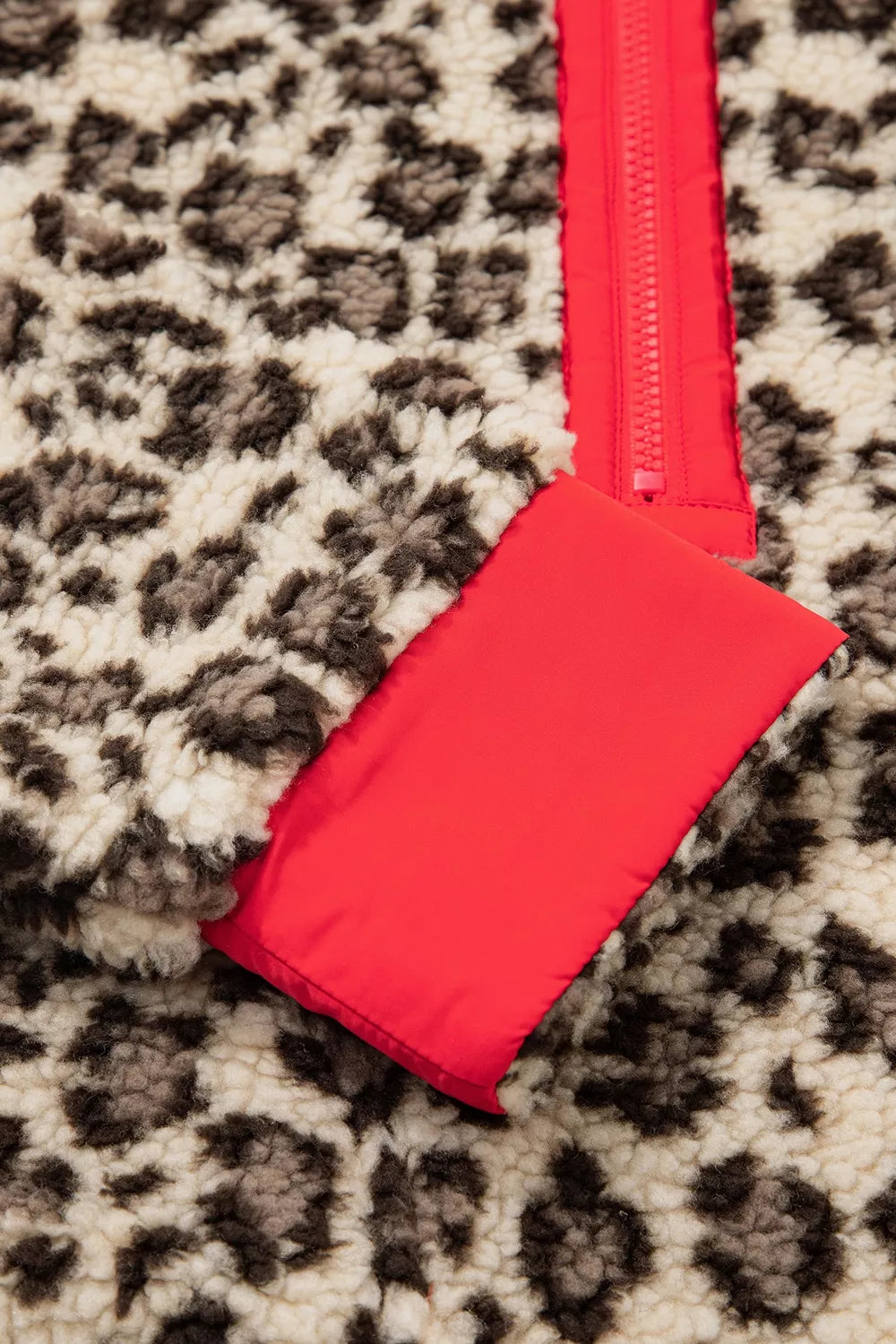 Leopard leopard half-zip sweatshirt with red trim, red cuff and sleeve trim detail.