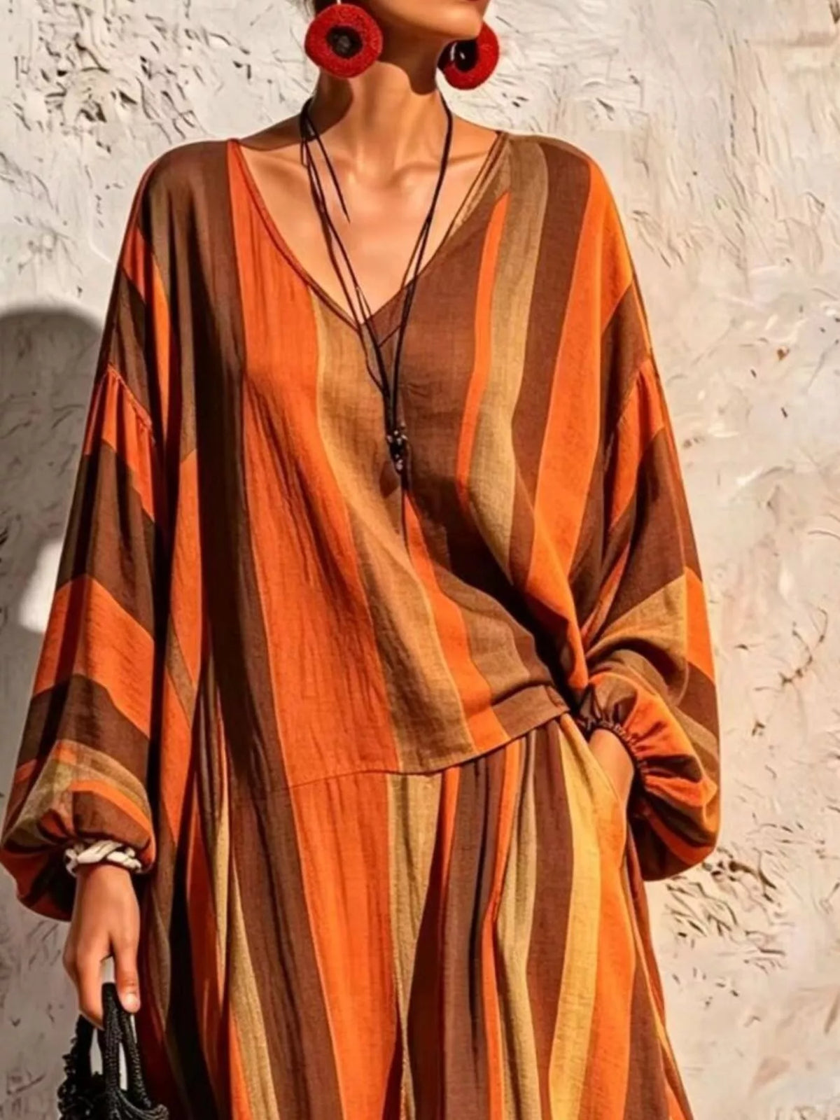 Orange and brown striped v-neck top and wide-leg pants set, top and neckline detail.