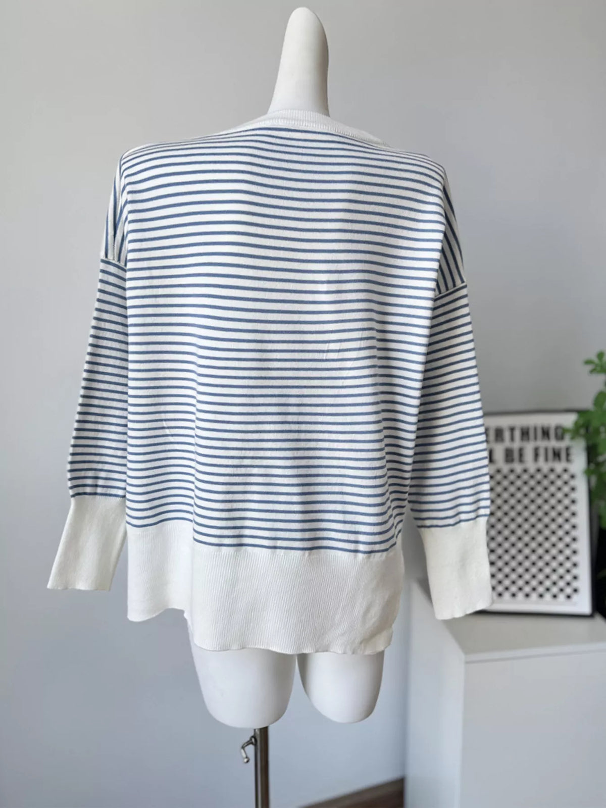 Striped round-neck knit top in white and blue, back mannequin view