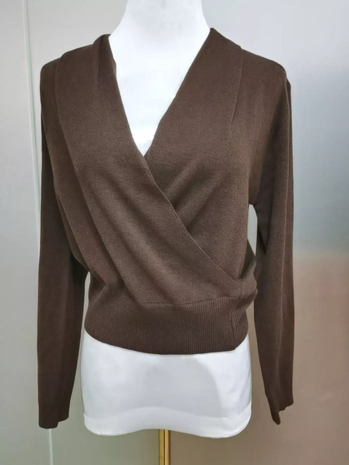 Brown wrap-front sweater, front on mannequin