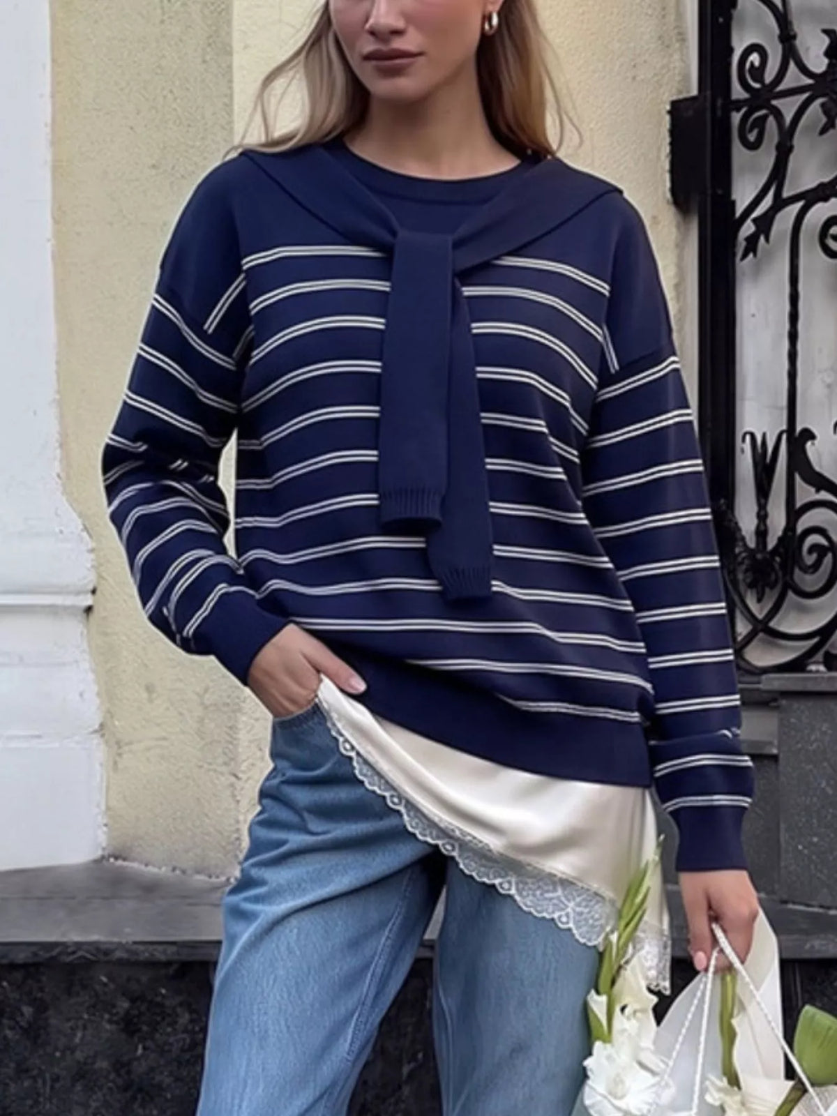 Striped crewneck sweater with layered tie detail in navy, front view on model