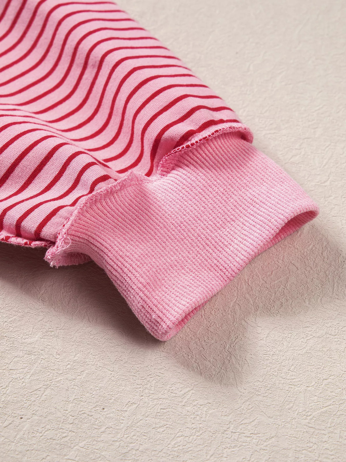 Ribbed cuff on pink and red striped striped color-block mock neck sweatshirt