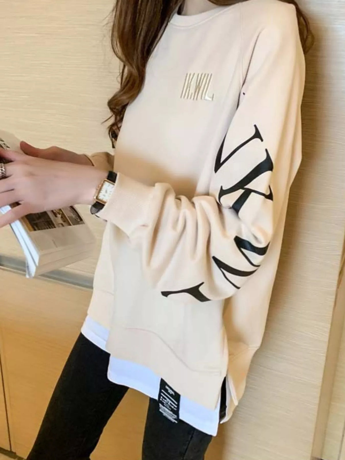 Apricot layered-hem sweatshirt with graphic sleeve detail