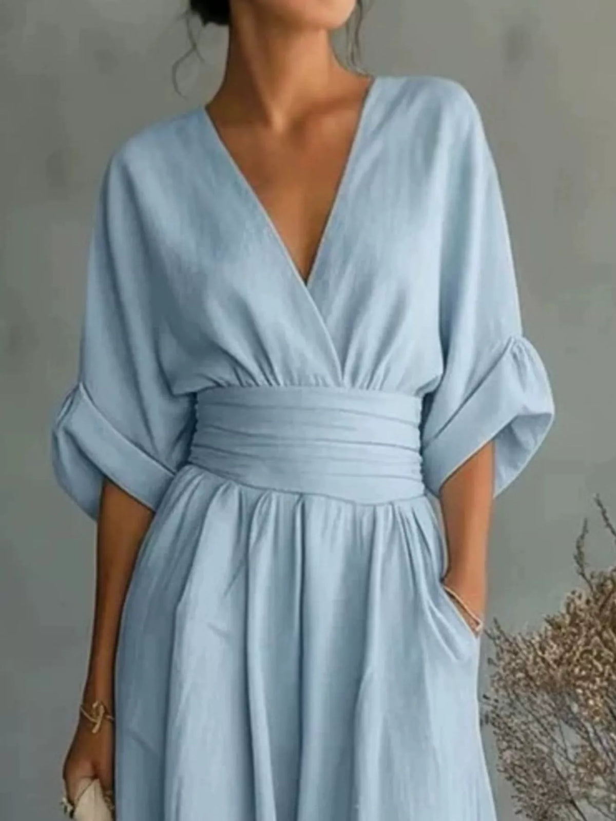 Light blue V-neck wide-leg jumpsuit, neckline and waist detail