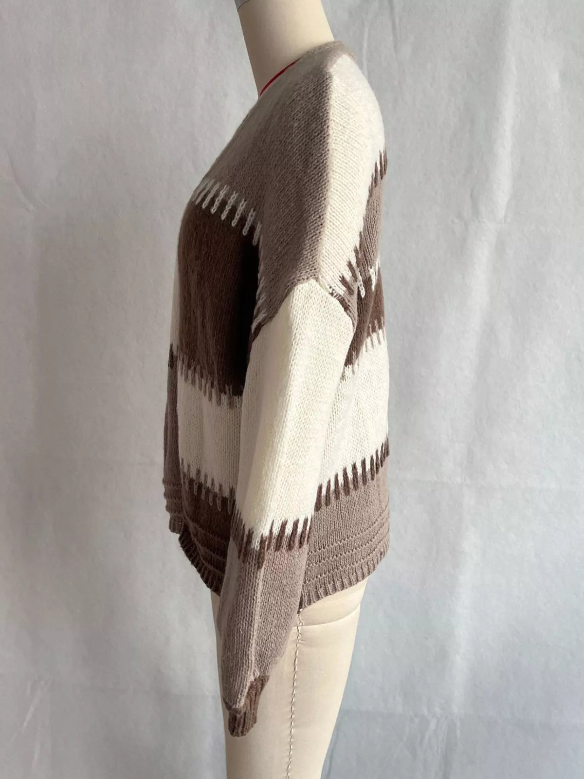 Brown color-block v-neck cardigan, side on dress form.