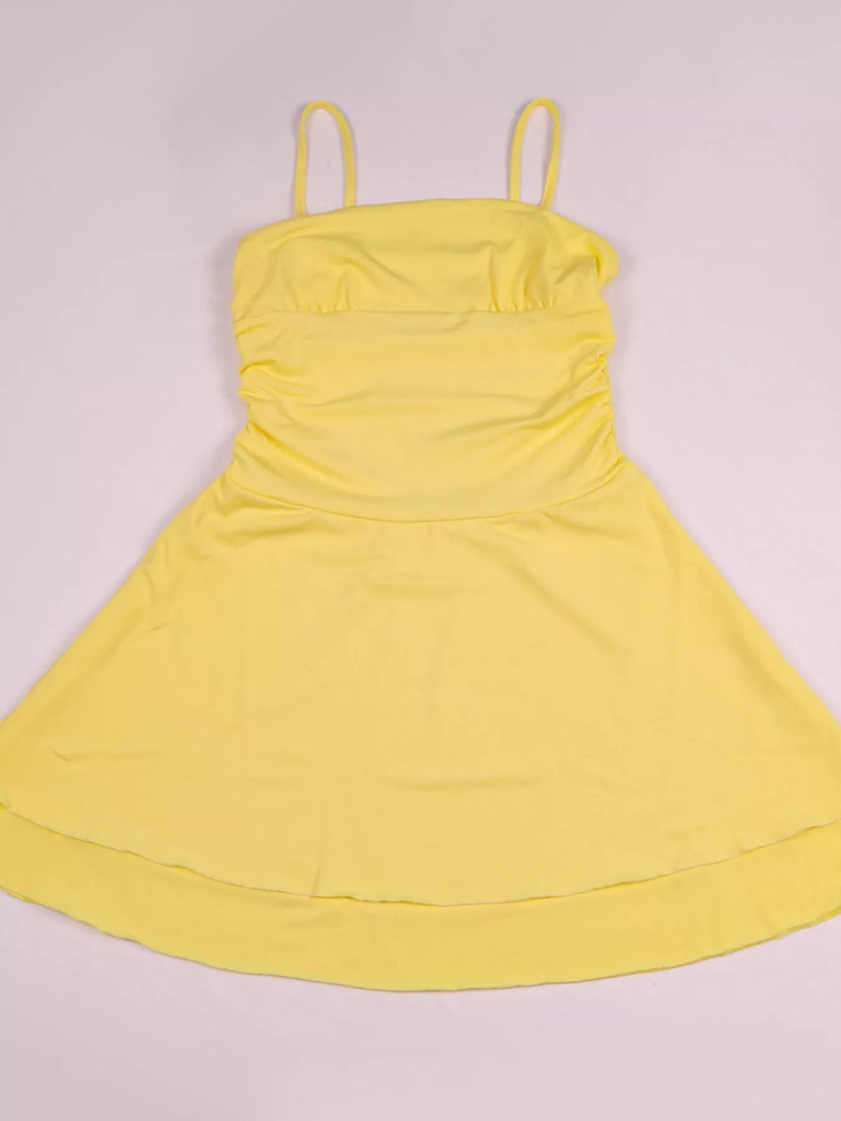 Yellow ruched spaghetti strap layered mini dress, flat lay