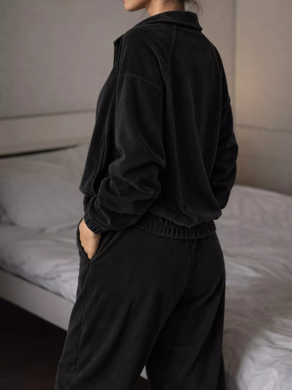 Black zip-up outerwear and pants set — back view