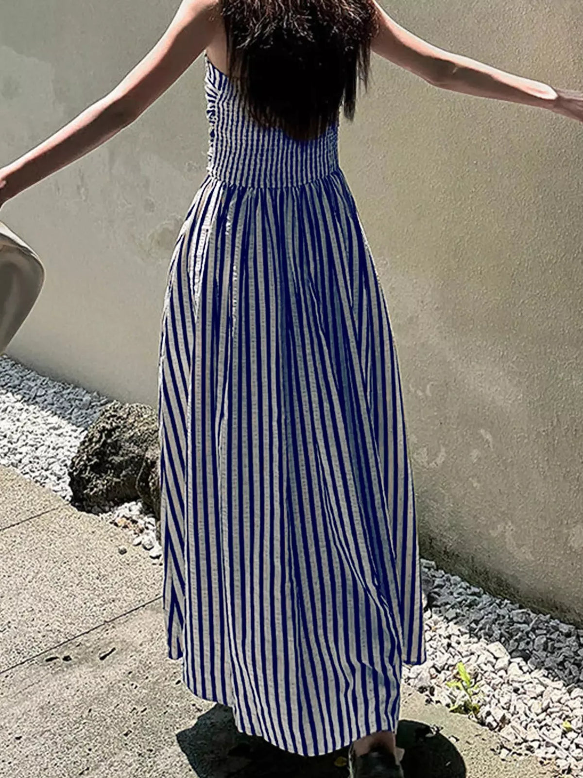 Navy and white striped spaghetti strap maxi dress with gathered bodice and pockets, back view