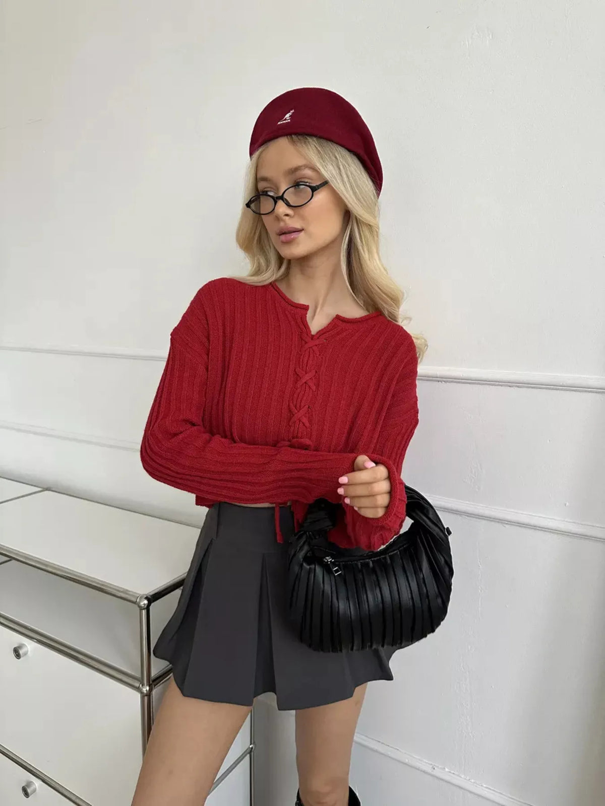 Red ribbed lace-up cropped sweater, standing front view.
