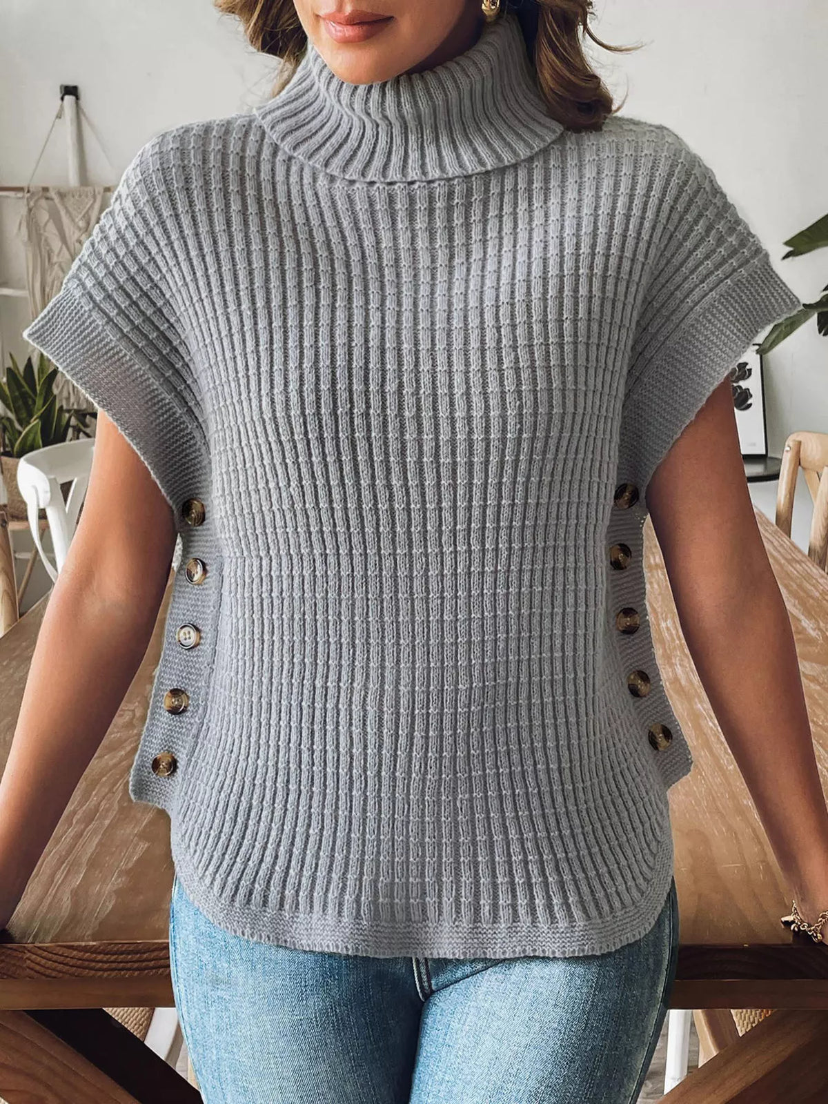 Gray ribbed turtleneck side-button sweater, front view showing curved hem.