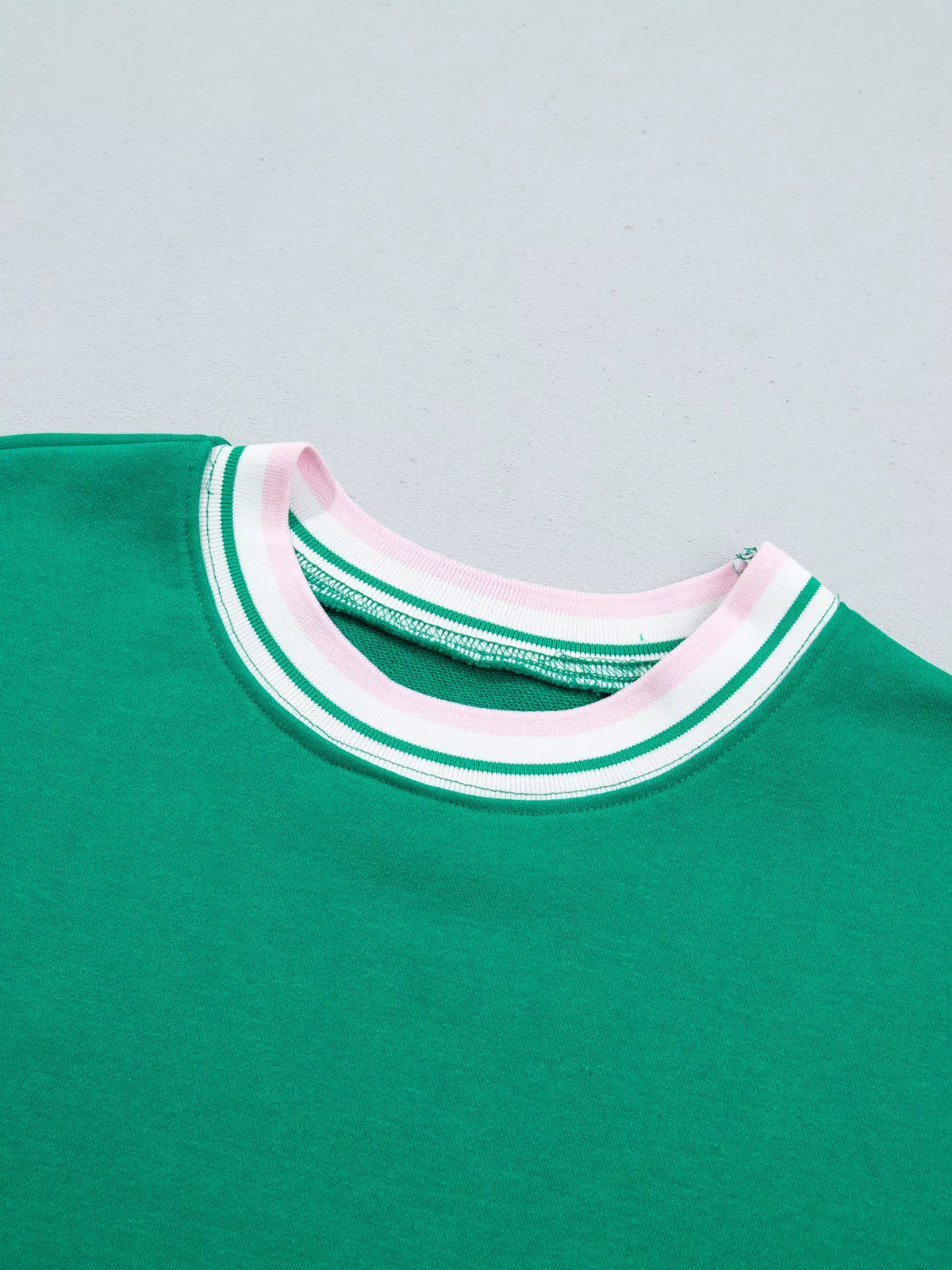 Green sweatshirt with contrast striped ribbed trim, neckline detail