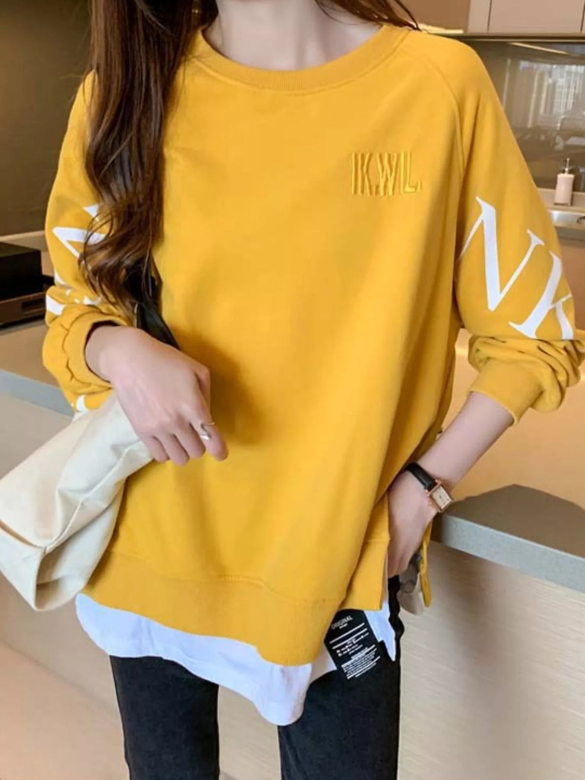 Yellow layered-hem sweatshirt with graphic sleeve detail