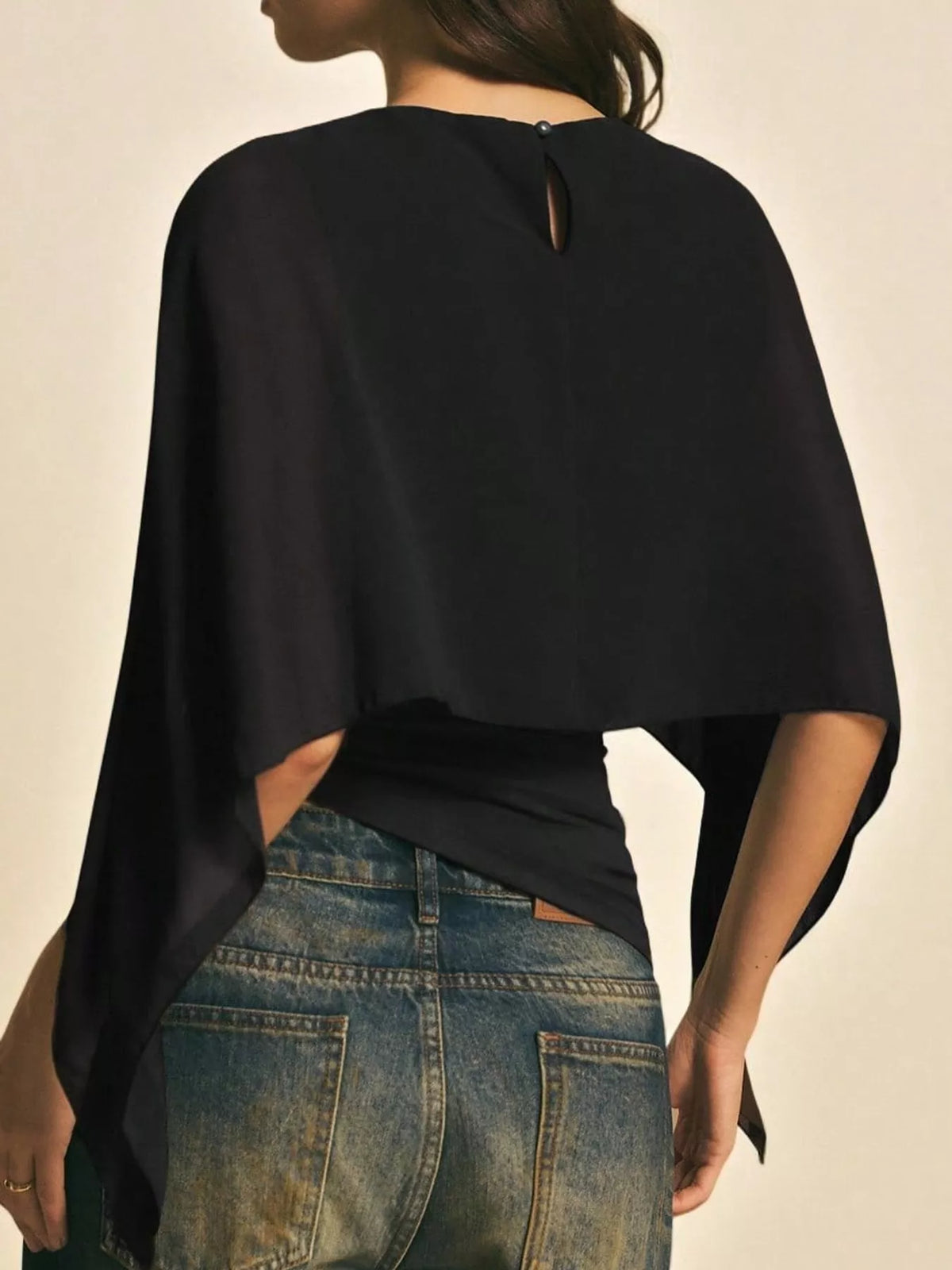 Black cape sleeve round neck blouse, back view
