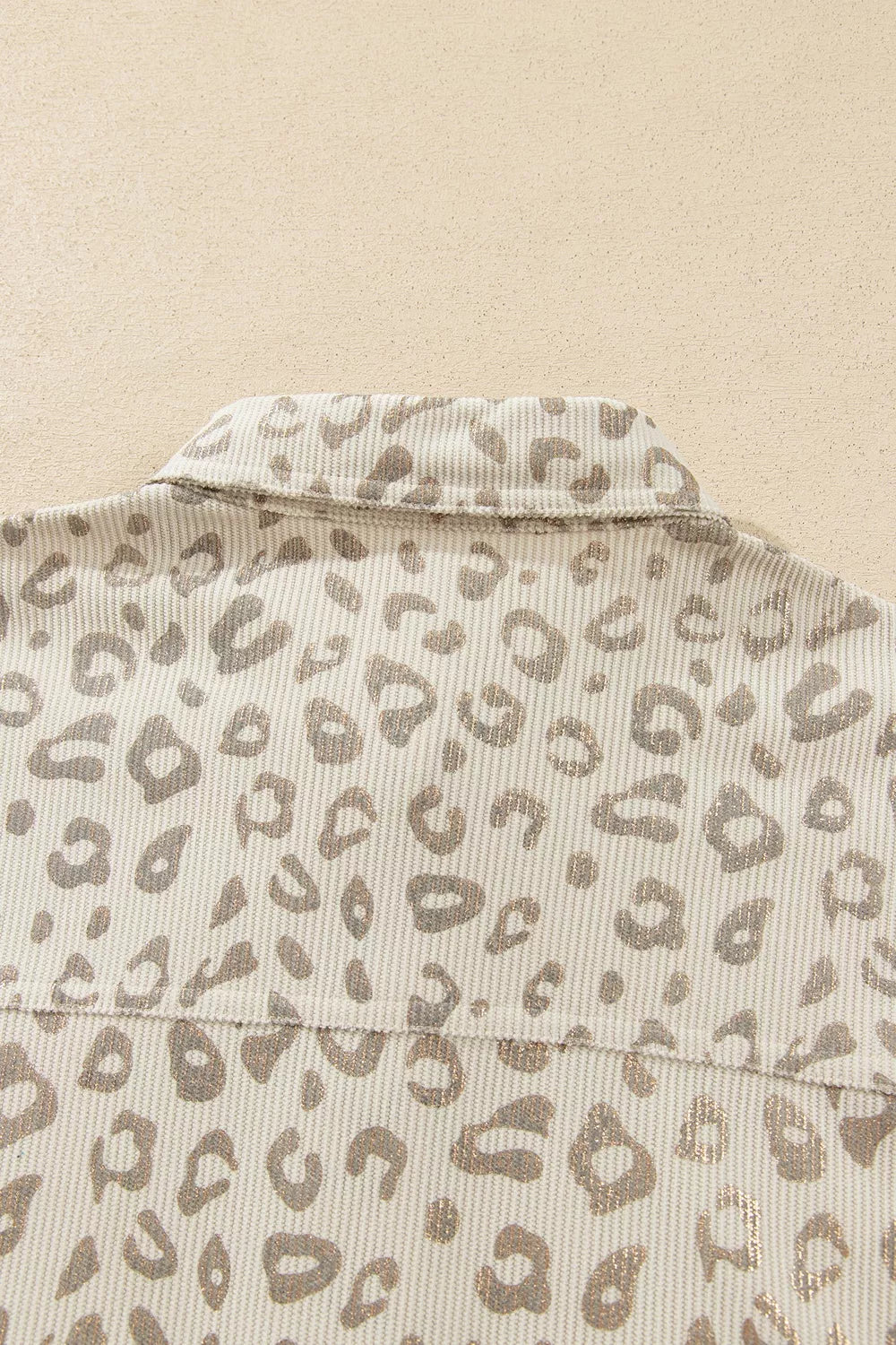 Beige leopard corduroy button-front jacket, back yoke detail.
