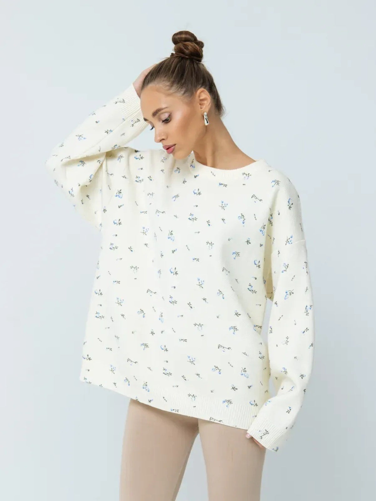White floral dropped-shoulder oversized sweater, standing front view.