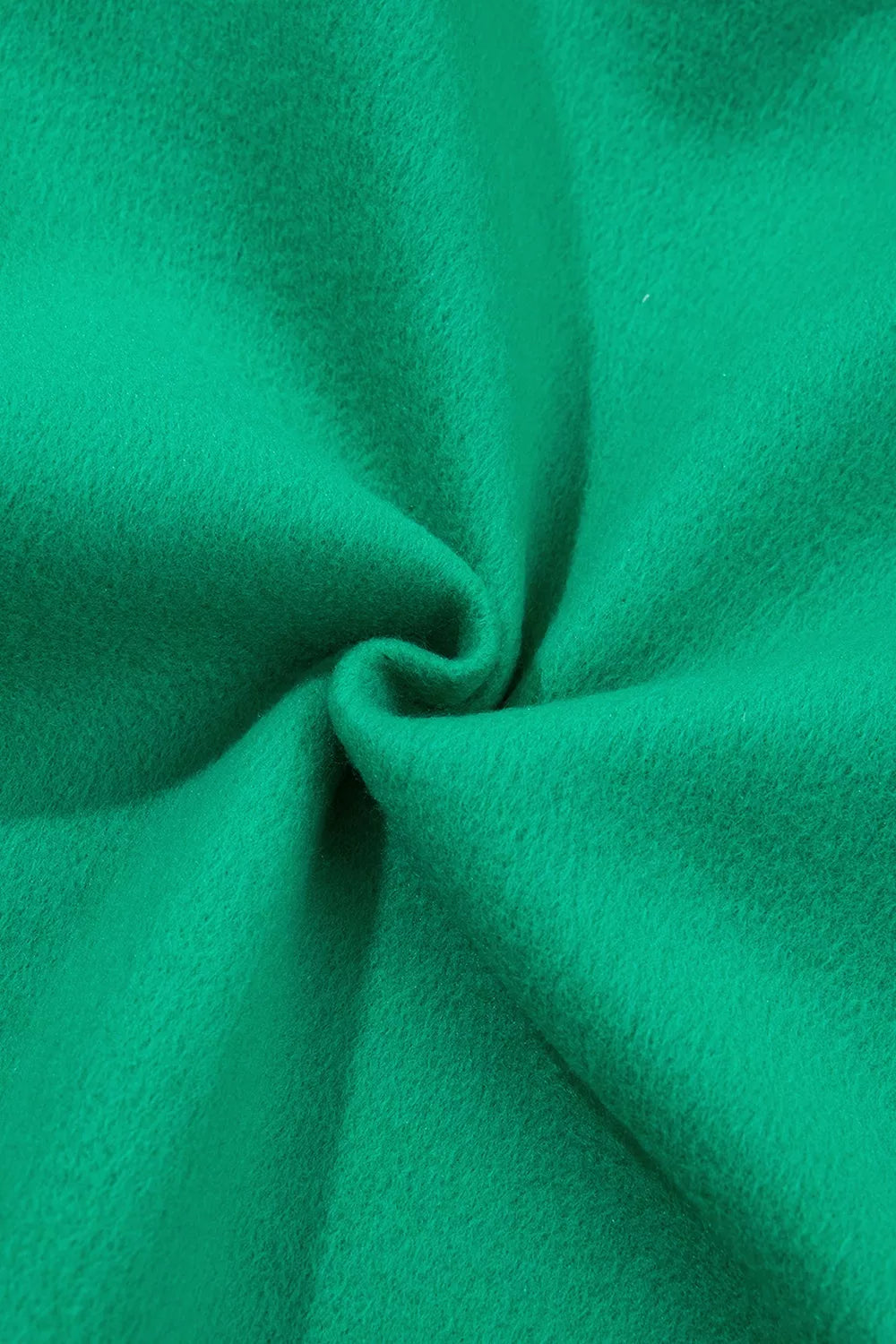Green sweatshirt and shorts set with polka-dot trim, fabric close-up