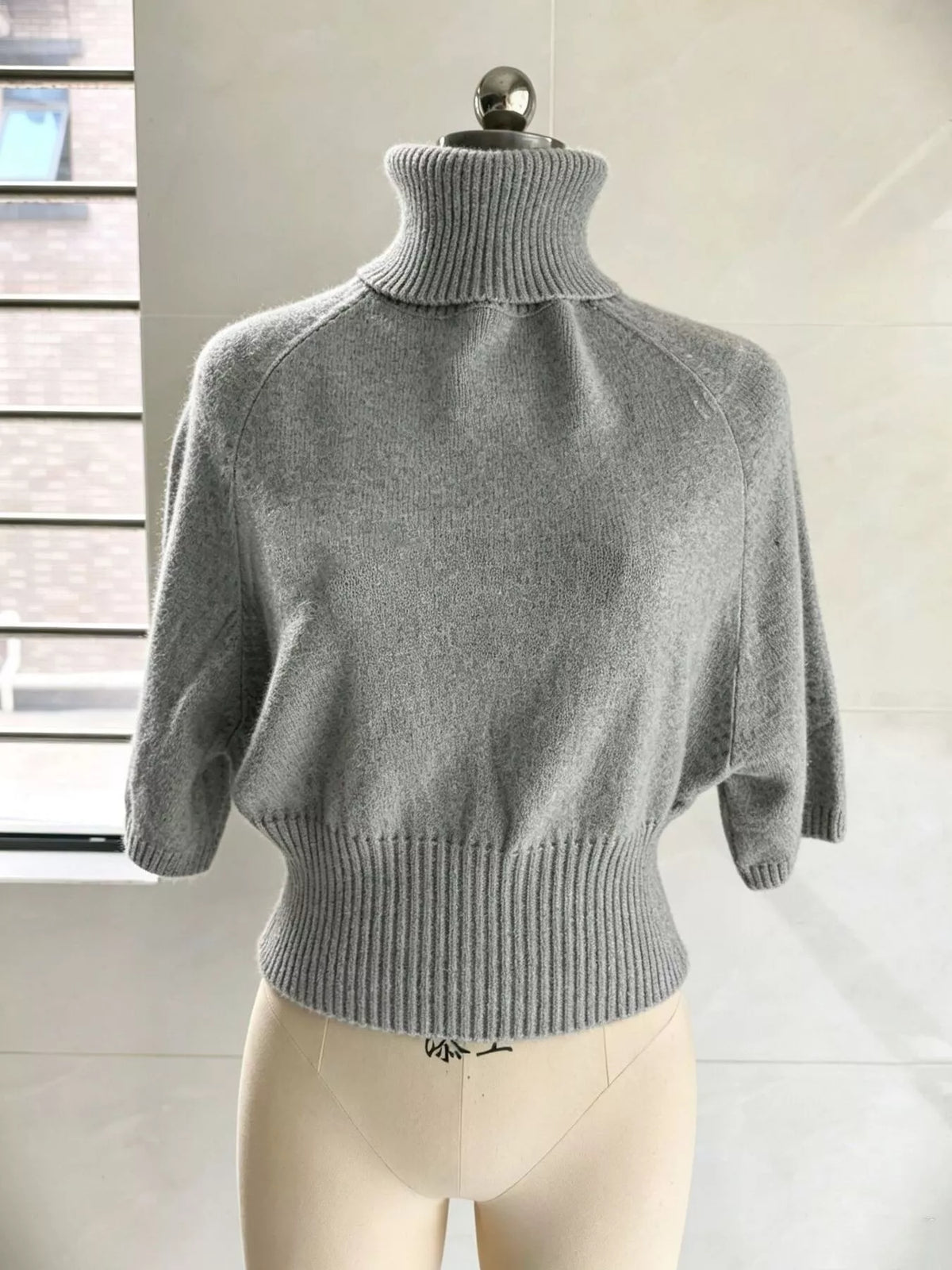 Turtleneck batwing top, gray mannequin front