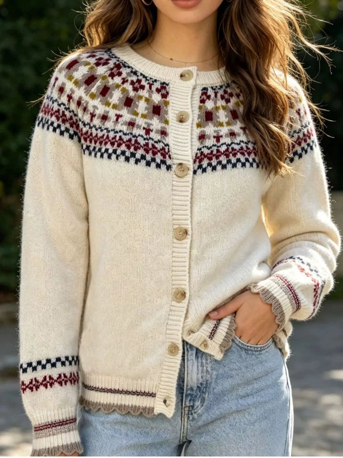 Cream fair isle button-front knit cardigan, front showing striped hem.