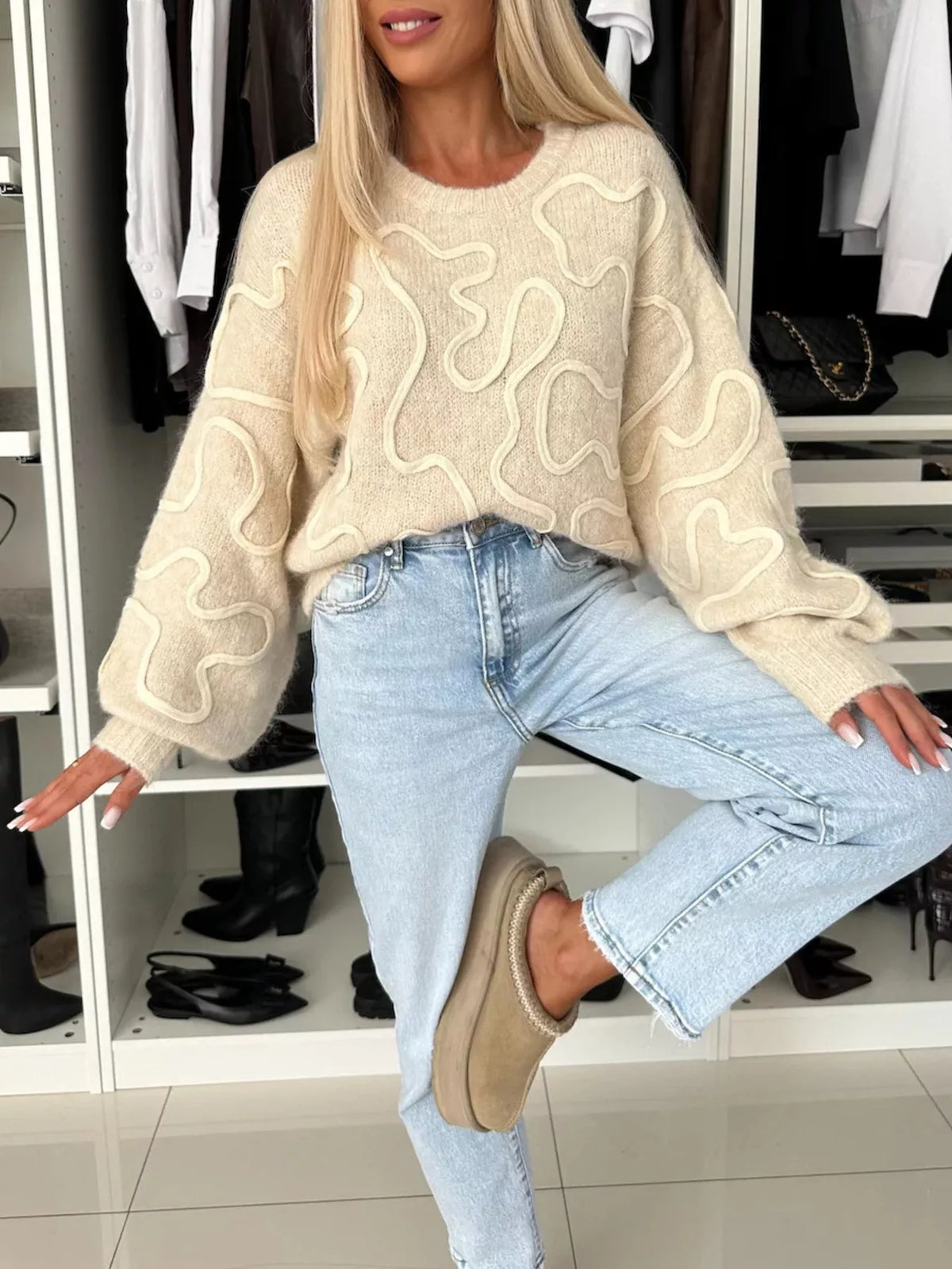 Beige abstract pattern oversized crewneck sweater, full front view.