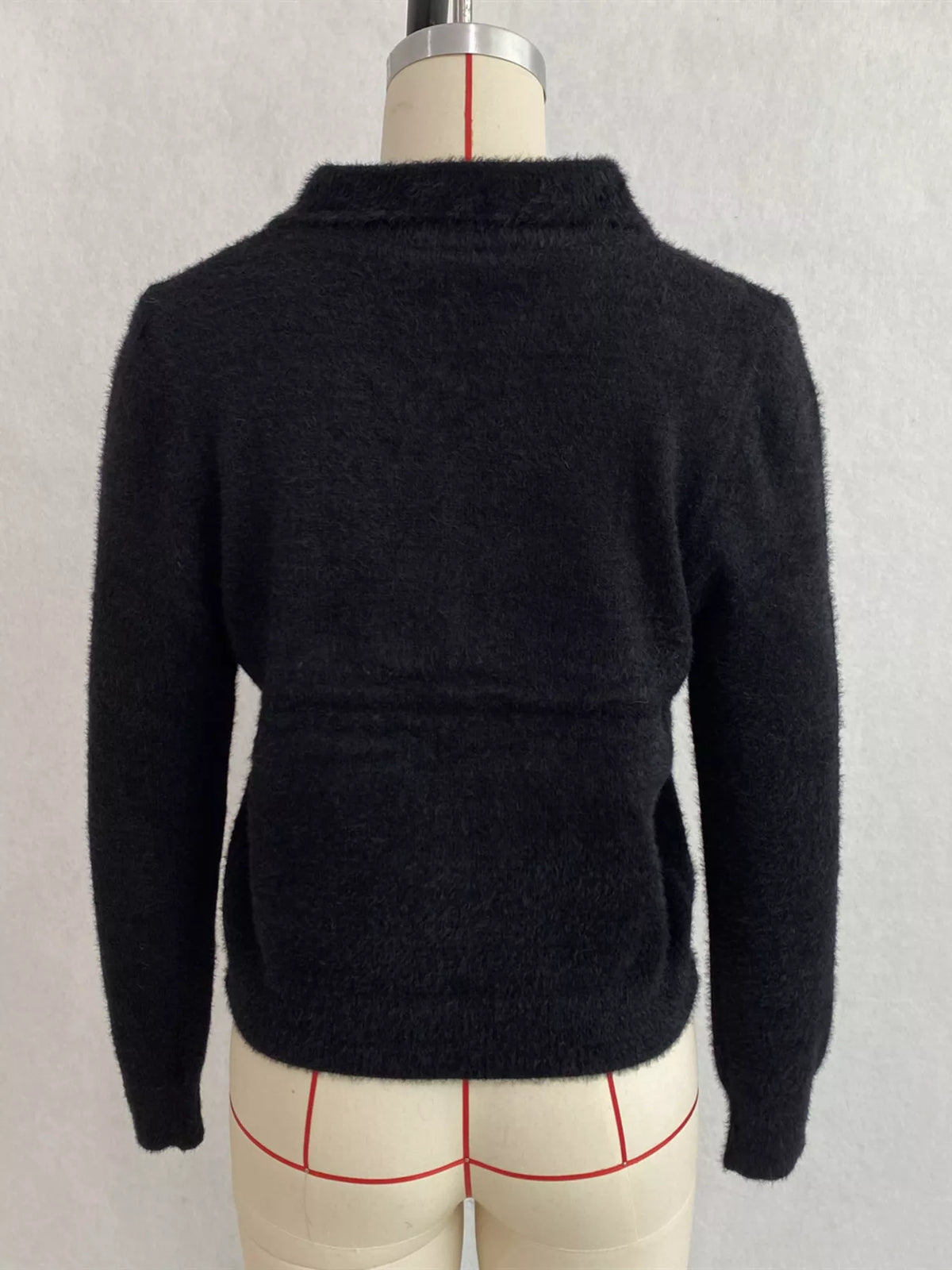 Black fuzzy letter zip-up cardigan, back on dress form.