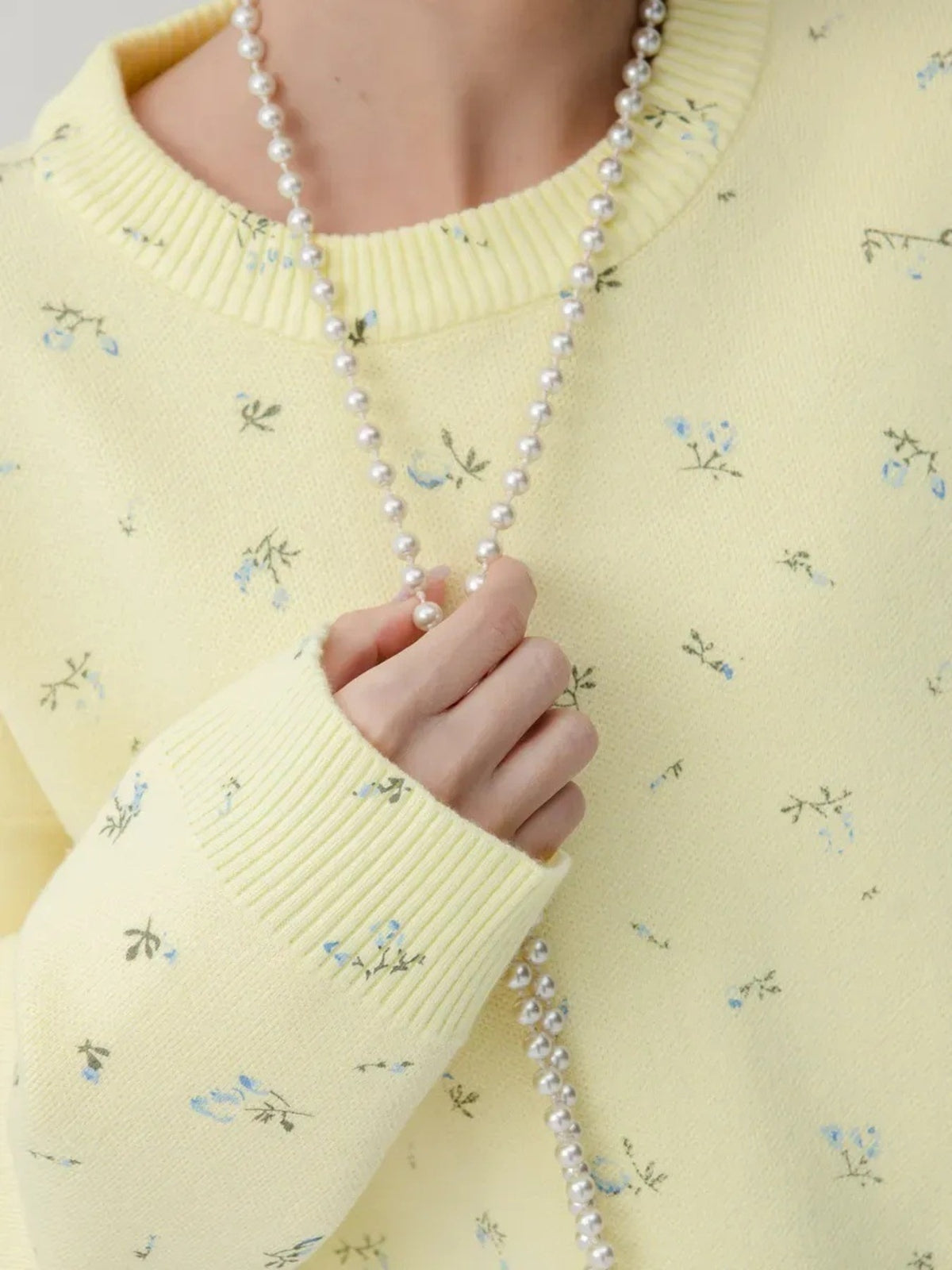 Yellow floral dropped-shoulder oversized sweater, neckline and cuff detail.