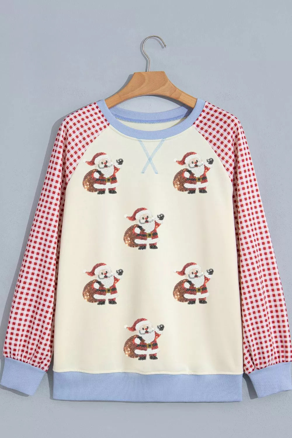 Cream Santa graphic sweatshirt with red plaid sleeves, front product view