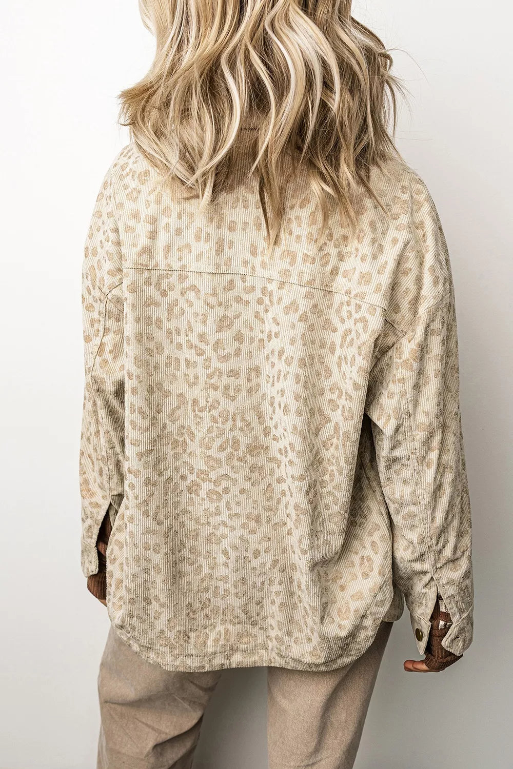 Beige leopard corduroy button-front jacket, back view.