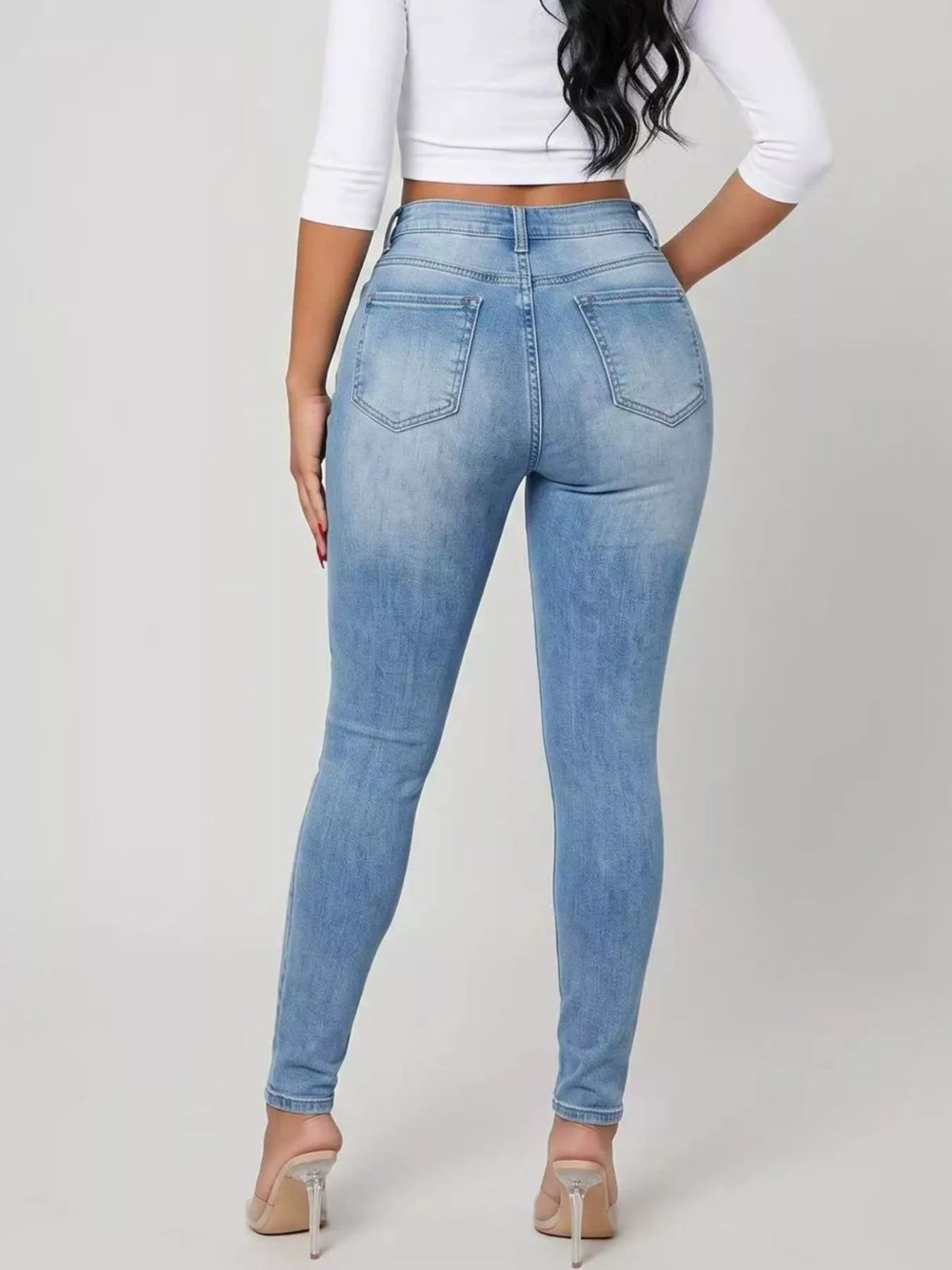 High-Waisted Distressed Skinny Jeans in light blue, back view
