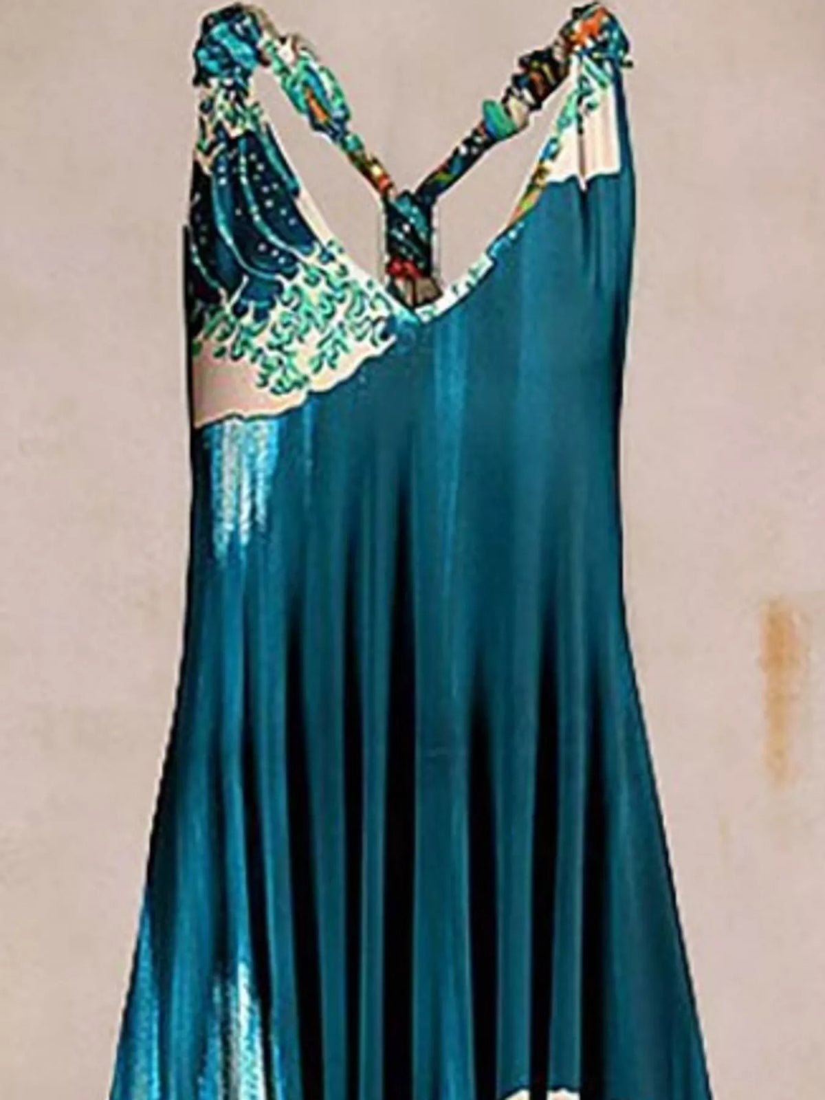 Teal wave-print V-neck sleeveless jumpsuit, neckline and strap detail